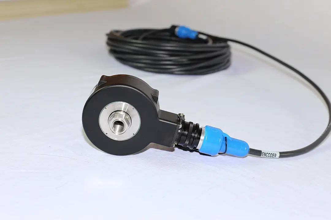 Black drawworks encoder with a blue connector and a coiled cable labelled Encoder.